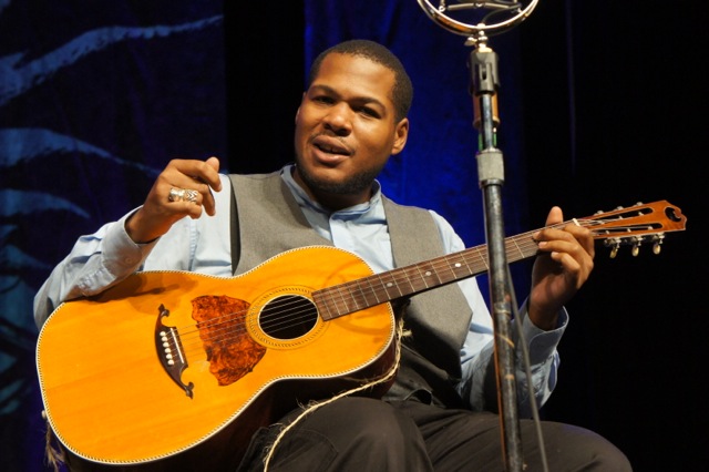 Jerron Paxton performing for the assembled students, teachers and program crew.