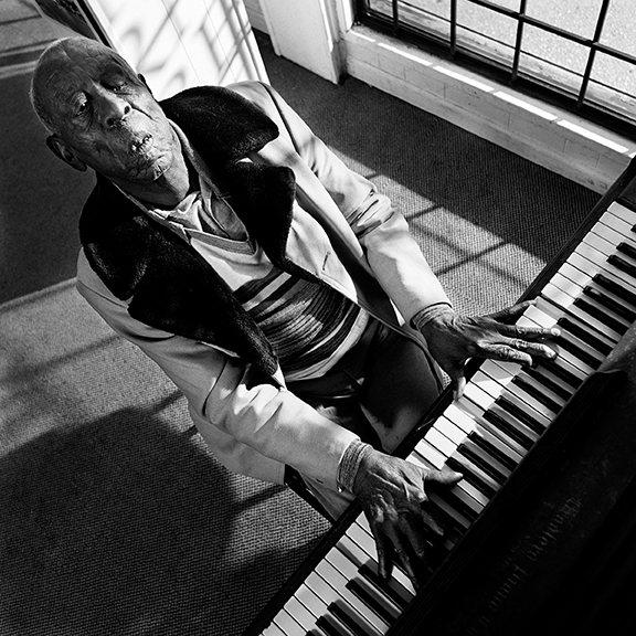 Sun Session Man Mose Vinson Memphis, TN 1995 Mose Vinson was one of the last practitioners of genuine barrelhouse blues piano. Originally from Holly Springs Mississippi, Vinson moved to Memphis in 1932 and played jukes and house parties through the 1940’s. In the early 1950’s Vinson worked as a clean-up man at Sun Studios in Memphis. Between recording sessions, Mose would sit at the piano and play “44 Blues” so often he eventually convinced Sam Phillips to record him in 1954. In addition, he also appeared on records by James Cotton, Walter Horton, Joe Hill Louis and others, although his own Sun sides went unreleased for 30 years. Mose’s first full-length CD was finally released in 1997. He spent the last two decades of his life as an ambassador for Memphis Blues, primarily playing educational and cultural festivals associated with the Center for Southern Folklore. Vinson died from diabetes in Memphis in 2002.