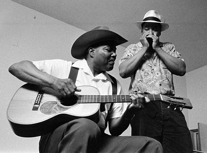 musicians playing guitar and harmonica