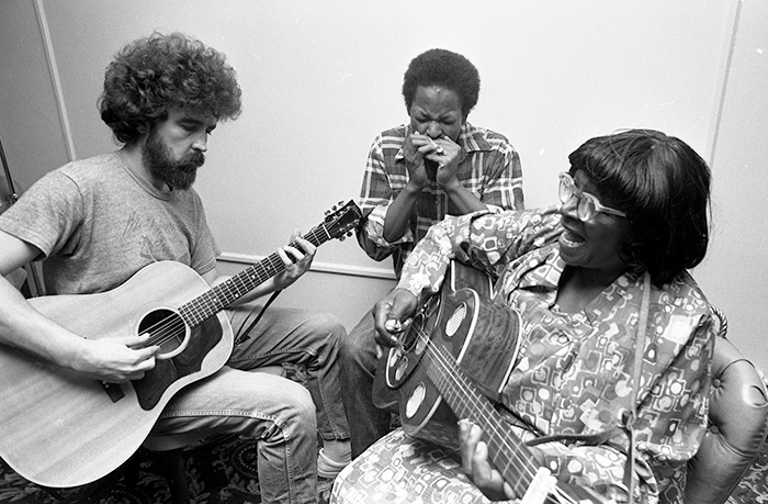 musicians playing guitar and harmonica
