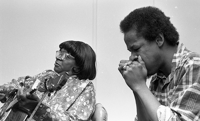 musicians playing guitar and harmonica