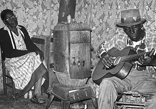 musicians playing guitar and woman listening