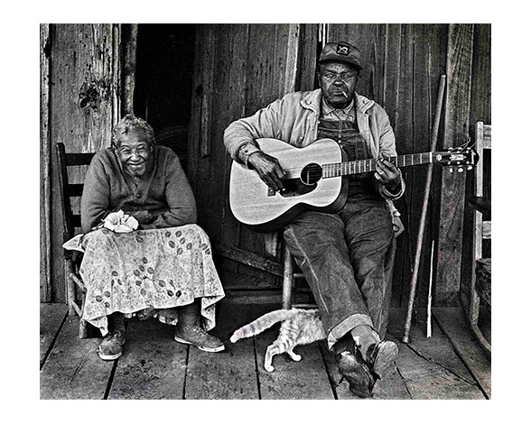 man playing guitar, woman listening