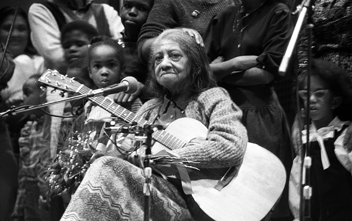 woman with guitar and children