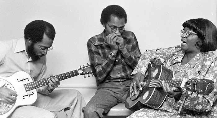 musicians playing guitar and harmonica
