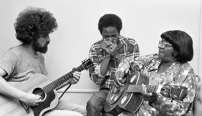musicians playing guitar and harmonica