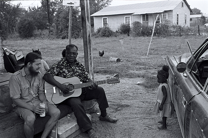 man playing guitar outside