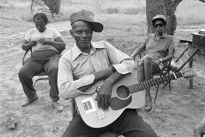 people sitting outside with guitar