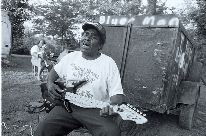 man playing guitar and singing