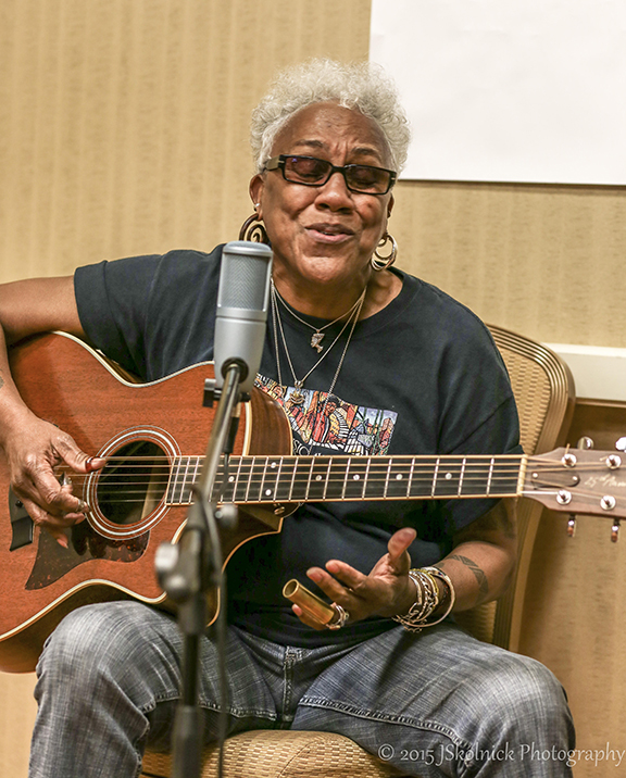 woman singing and playing guitar