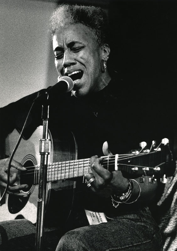 woman singing and playing guitar