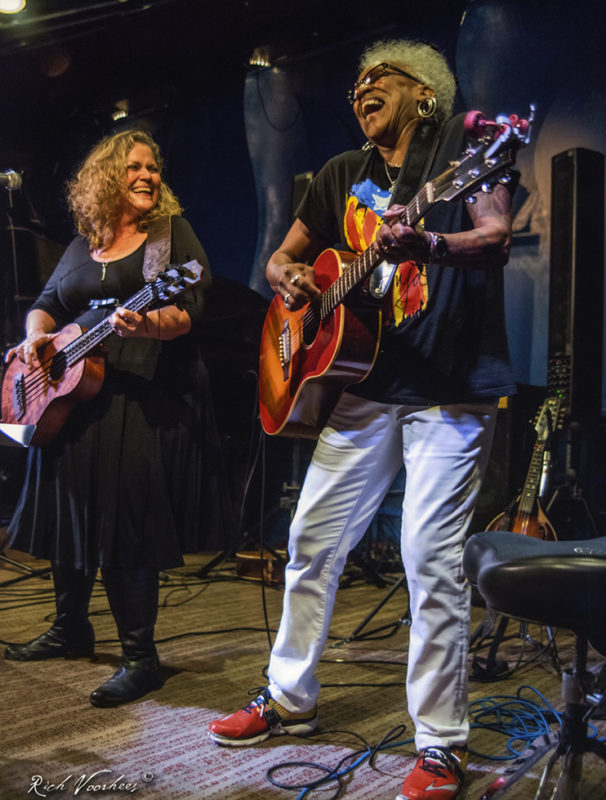 2 women playing guitars