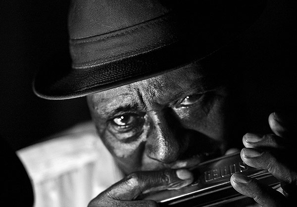 man playing harmonica