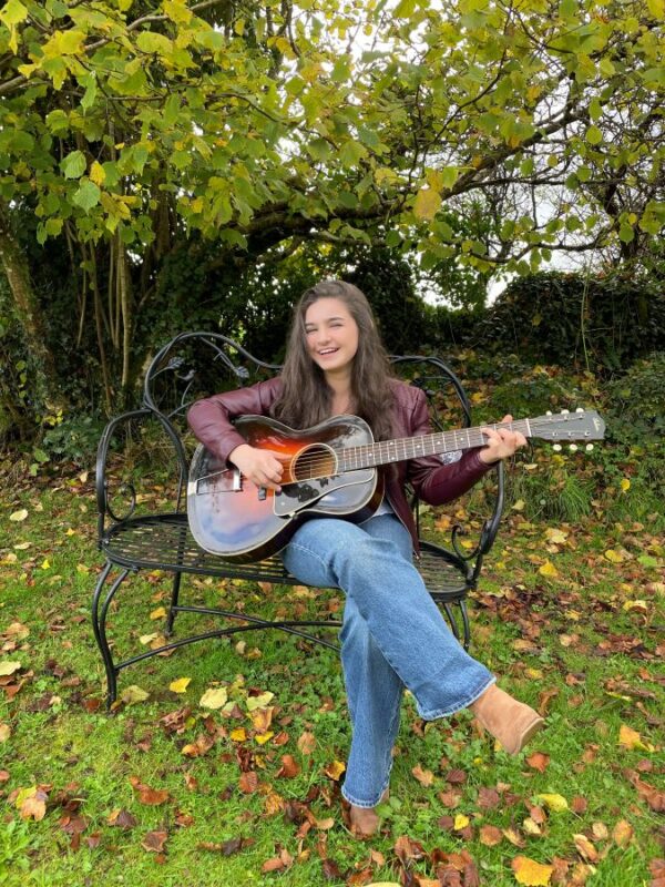 Muireann Bradley with guitar outdoors