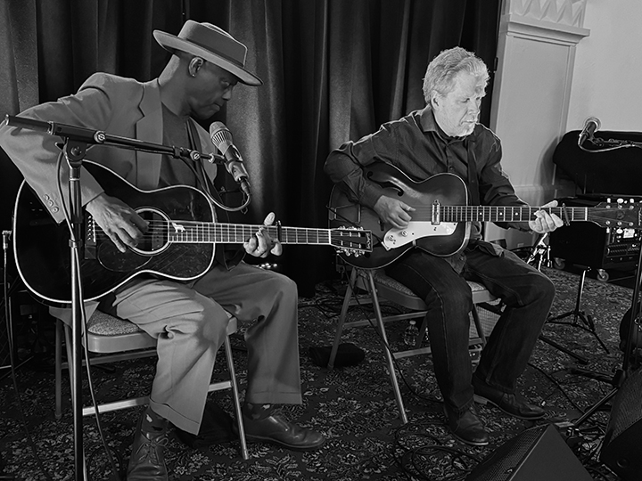 Eric Bibb and Michael Jerome Browne playing guitar